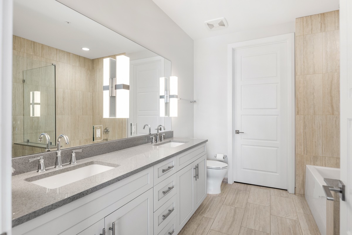 20 Rutledge Street, Unit 407 Nashville, TN 37210 - Photo 23 of 56 a spacious bathroom with a double vanity sink a mirror and a shower