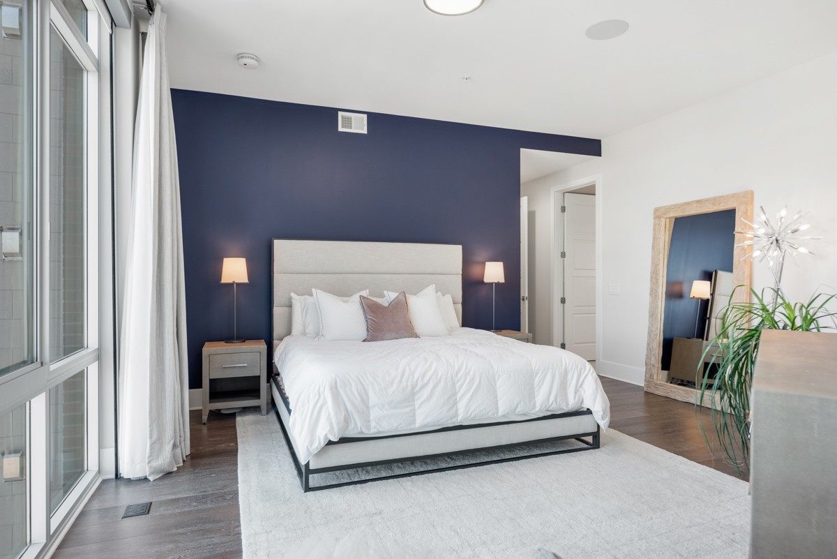 20 Rutledge Street, Unit 407 Nashville, TN 37210 - Photo 26 of 56 a bedroom with a bed lamp and a potted plant