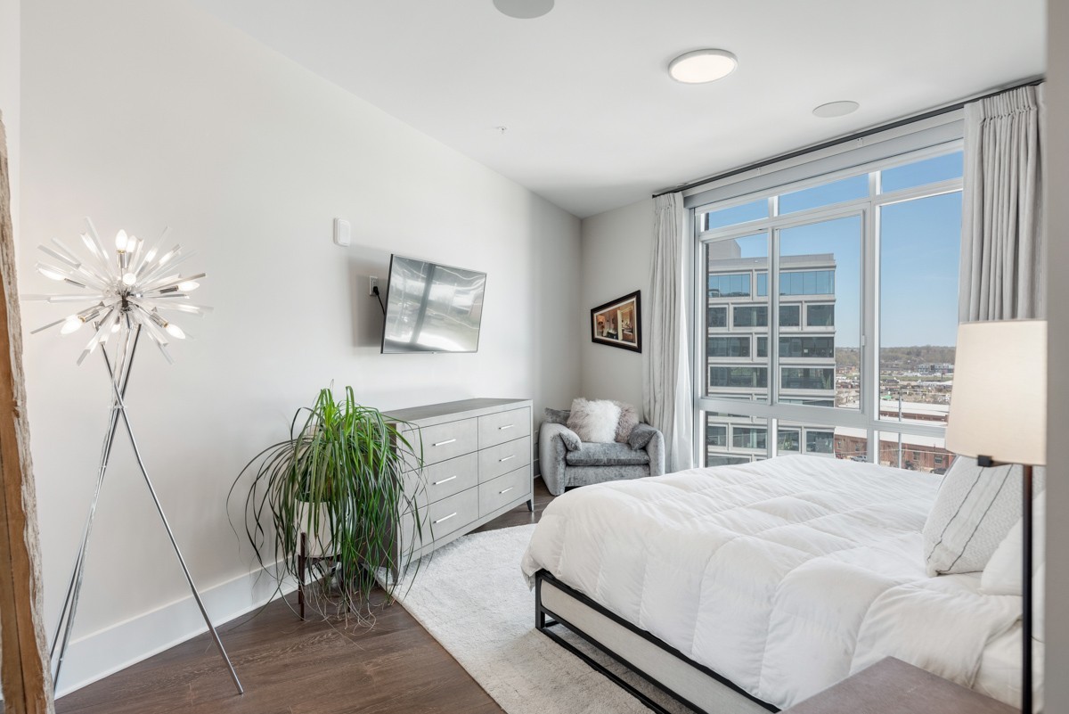 20 Rutledge Street, Unit 407 Nashville, TN 37210 - Photo 27 of 56 a bedroom with a bed and a potted plant