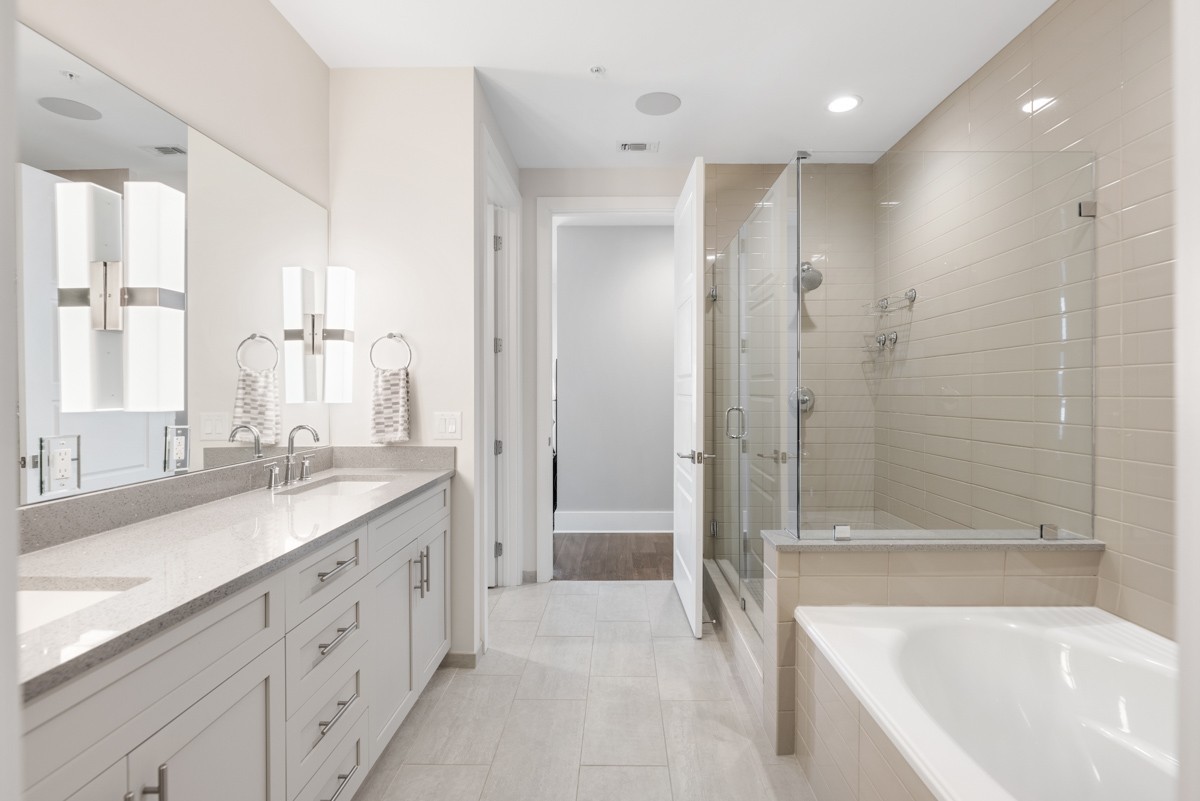 20 Rutledge Street, Unit 407 Nashville, TN 37210 - Photo 30 of 56 a bathroom with a granite countertop sink mirror bathtub and next to a window
