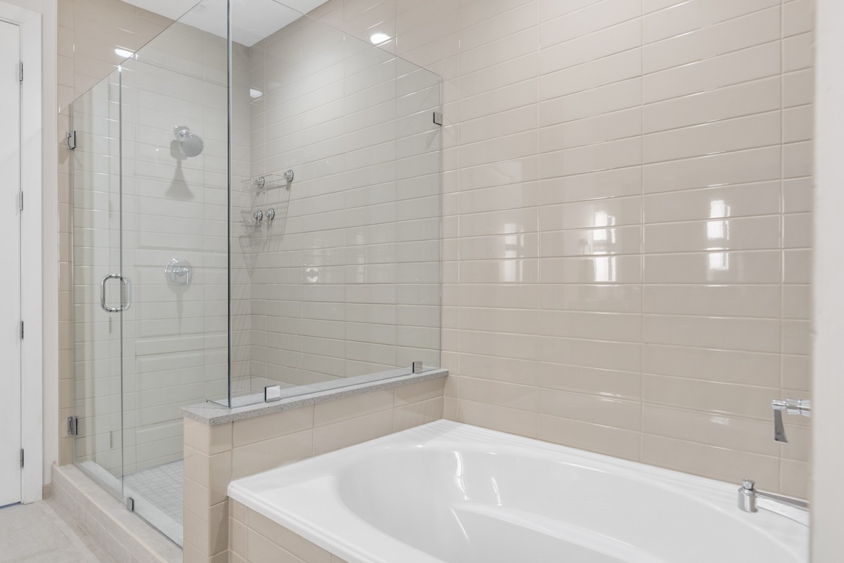 20 Rutledge Street, Unit 407 Nashville, TN 37210 - Photo 31 of 56 a white bath tub sitting next to a shower