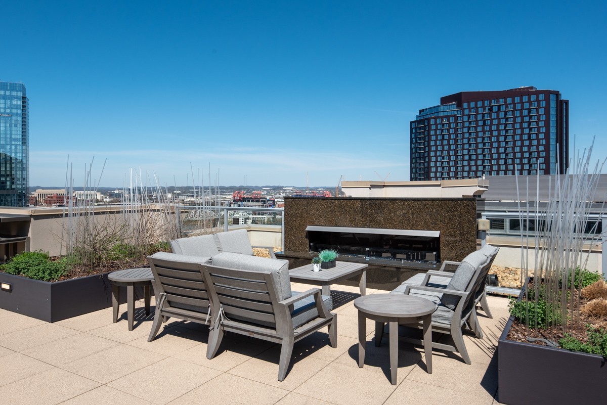 20 Rutledge Street, Unit 407 Nashville, TN 37210 - Photo 44 of 56 a roof deck with a table and chairs
