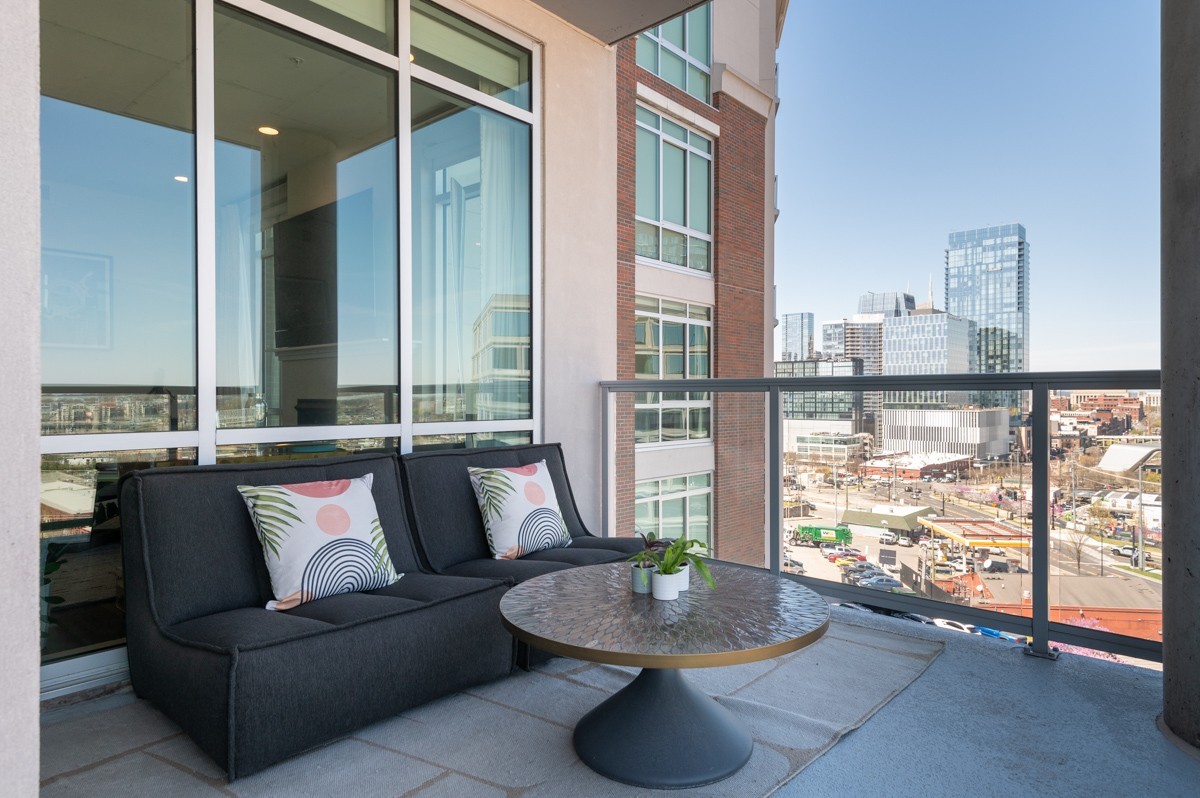 20 Rutledge Street, Unit 407 Nashville, TN 37210 - Photo 8 of 56 a living room with furniture and a floor to ceiling window