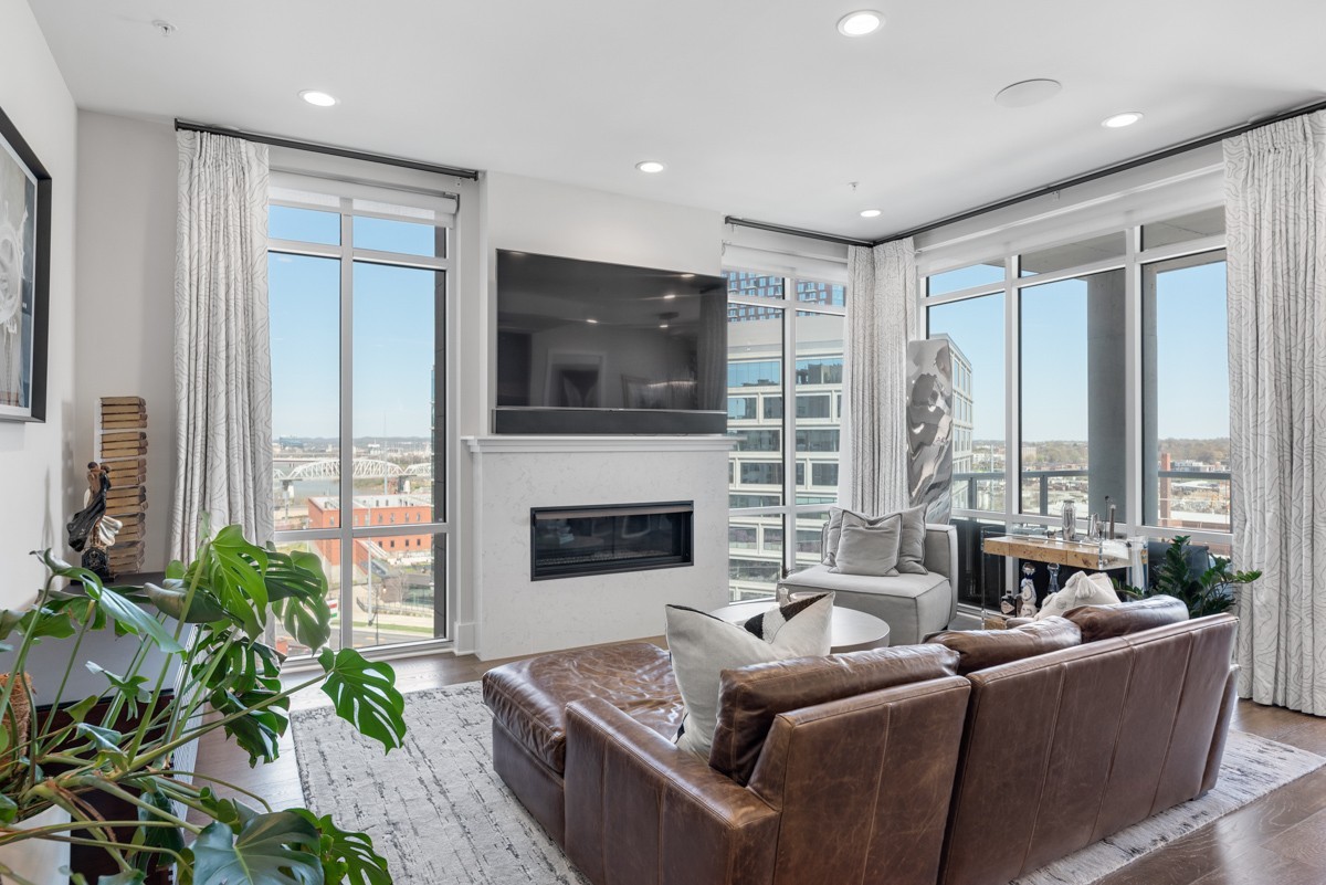 20 Rutledge Street, Unit 407 Nashville, TN 37210 - Photo 10 of 56 a living room with fireplace furniture and a flat screen tv