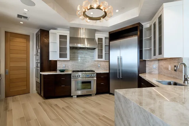 a kitchen with stainless steel appliances granite countertop a stove and a refrigerator