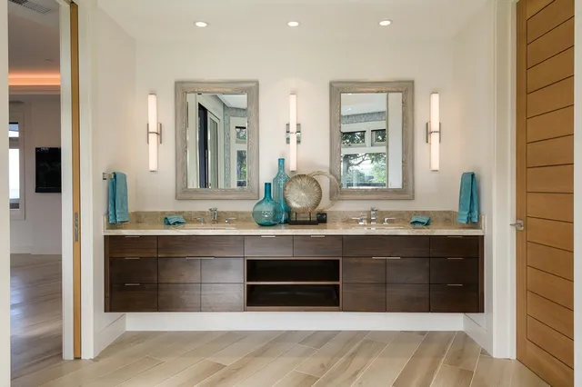a spacious bathroom with a sink and a mirror