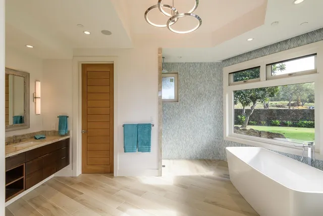 a large white kitchen with a large window