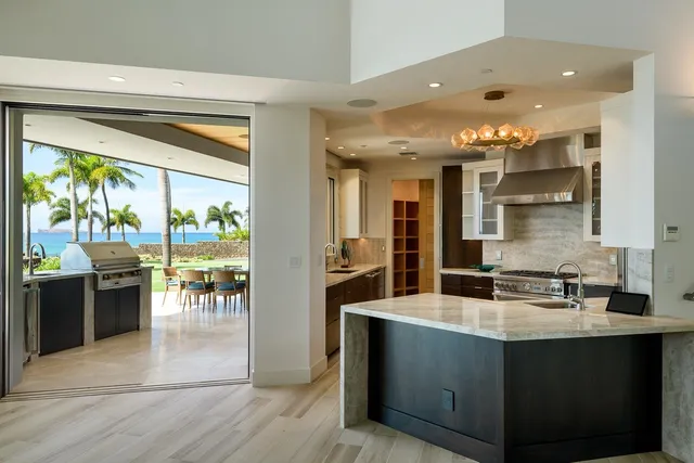 a kitchen with stainless steel appliances granite countertop a sink and a stove