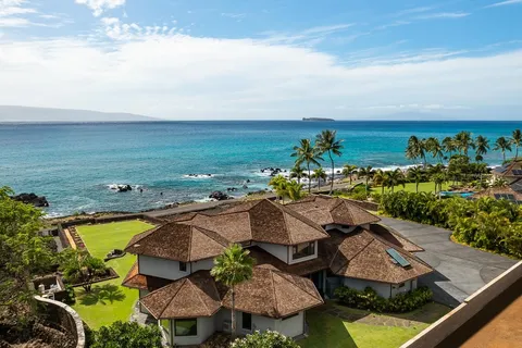 an aerial view of residential houses with outdoor space and swimming pool