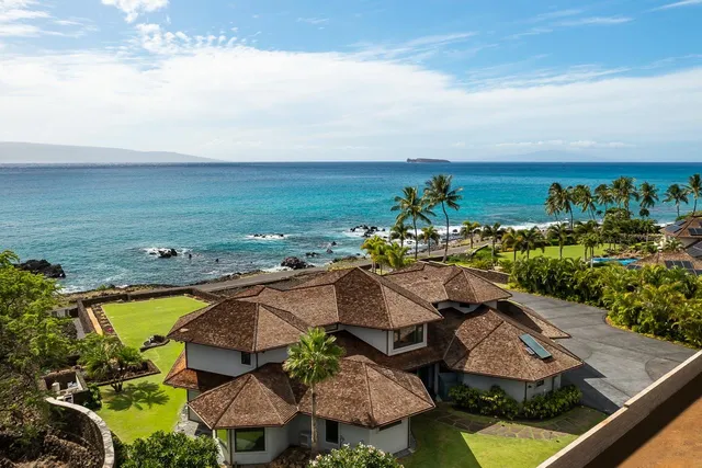 an aerial view of residential houses with outdoor space and swimming pool