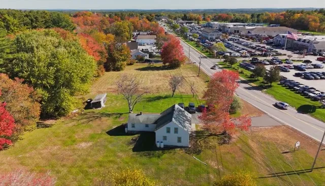 an aerial view of a house with yard swimming pool and outdoor seating