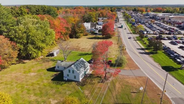 an aerial view of a house with a yard