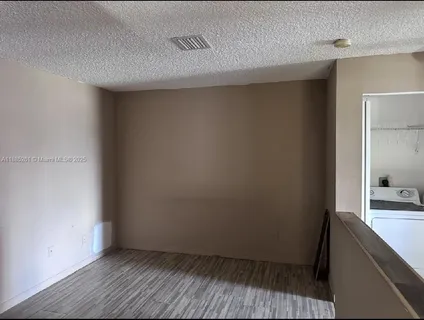 a view of hallway with wooden floor