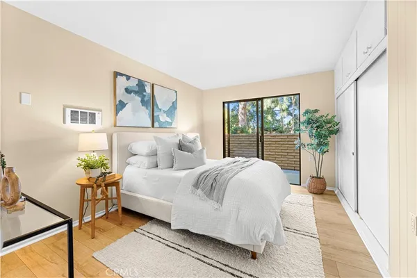 a bedroom with a bed and a large window