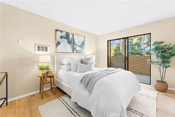 a bed room with a bed and a painting on the wall