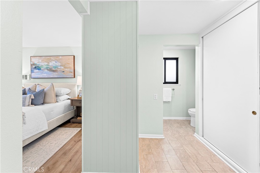 841 Ronda Sevilla, Unit B Laguna Woods, CA 92637 - Photo 21 of 37 a view of a bedroom with wooden floor and bed