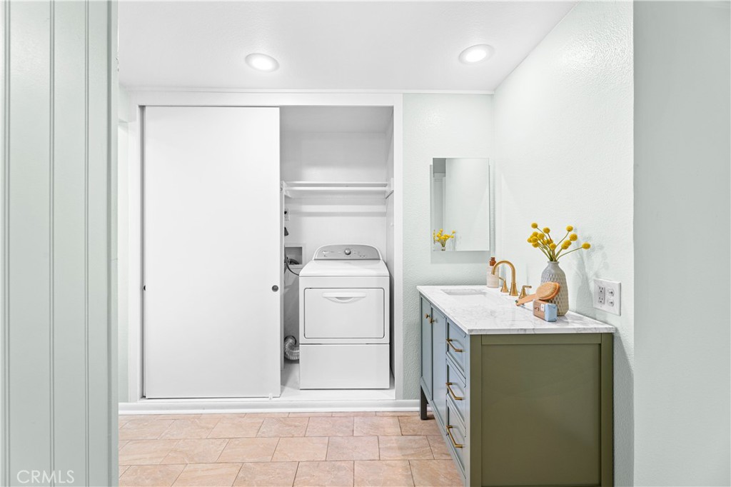 841 Ronda Sevilla, Unit B Laguna Woods, CA 92637 - Photo 22 of 37 a bathroom with a sink toilet and mirror