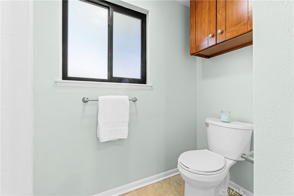 841 Ronda Sevilla, Unit B Laguna Woods, CA 92637 - Photo 24 of 37 a bathroom with a toilet sink and mirror