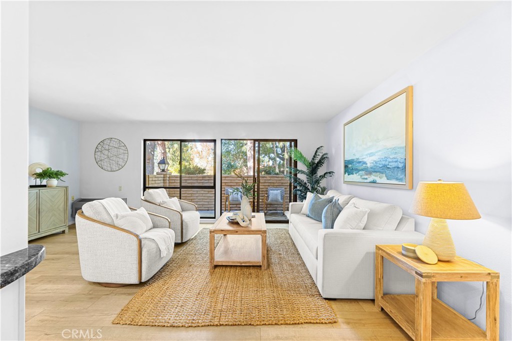 841 Ronda Sevilla, Unit B Laguna Woods, CA 92637 - Photo 4 of 37 a living room with a couch and a large window