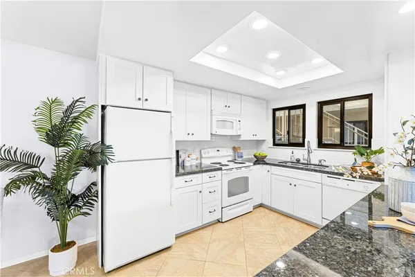 a kitchen with white cabinets and a stove