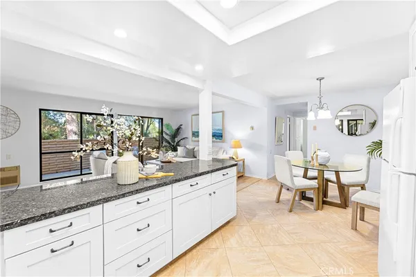 a spacious bathroom with a granite countertop sink mirror and next to a window