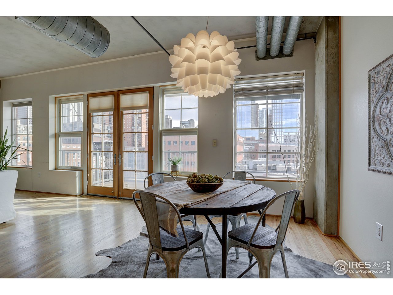 1499 Blake Street, Unit 6G Denver, CO 80202 - Photo 12 of 37 a view of a dining room with furniture wooden floor and chandelier