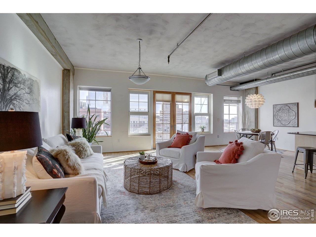 1499 Blake Street, Unit 6G Denver, CO 80202 - Photo 2 of 37 a living room with furniture fireplace and large windows