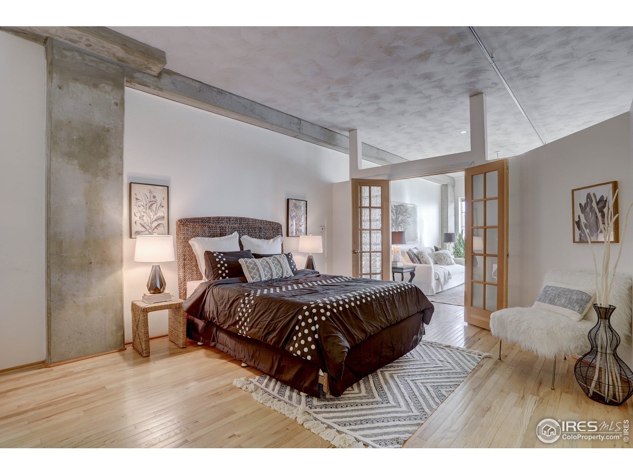 1499 Blake Street, Unit 6G Denver, CO 80202 - Photo 23 of 37 a bedroom with a bed and wooden floor