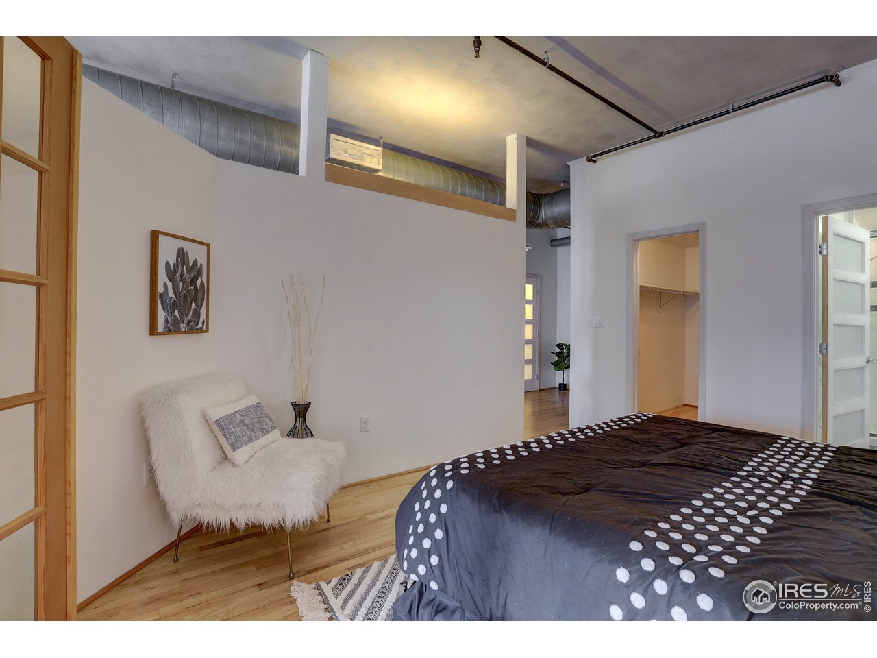 1499 Blake Street, Unit 6G Denver, CO 80202 - Photo 25 of 37 a bedroom with a bed and glass door