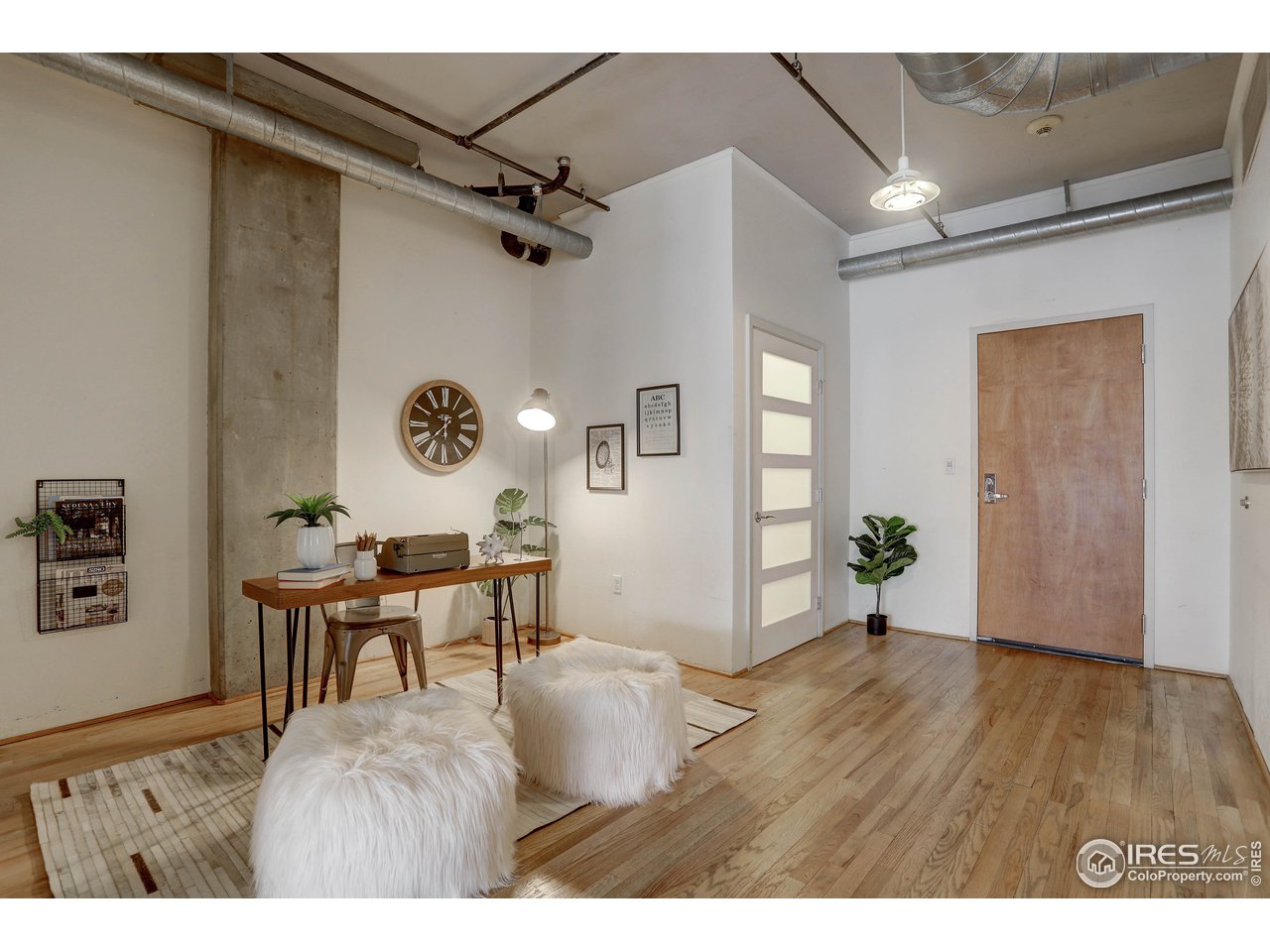 1499 Blake Street, Unit 6G Denver, CO 80202 - Photo 3 of 37 a view of a livingroom with furniture and hardwood floor