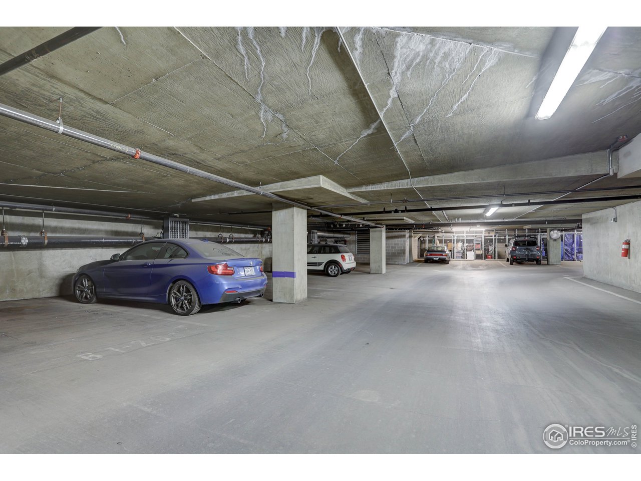 1499 Blake Street, Unit 6G Denver, CO 80202 - Photo 36 of 37 a view of parking garage with cars parked