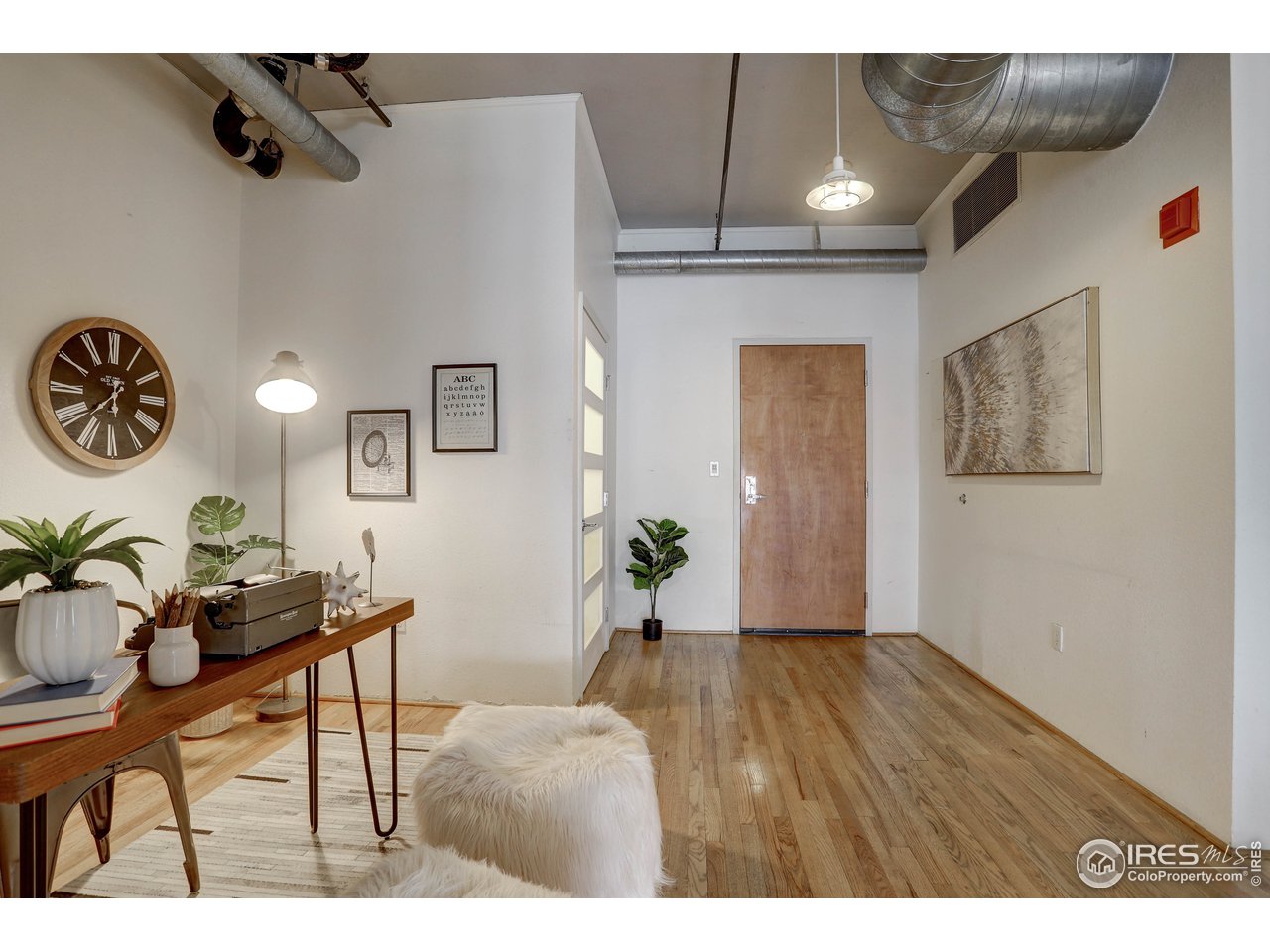 1499 Blake Street, Unit 6G Denver, CO 80202 - Photo 5 of 37 a view of an entryway with wooden floor