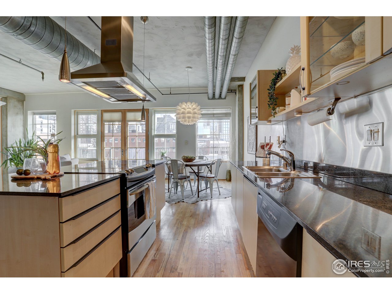 1499 Blake Street, Unit 6G Denver, CO 80202 - Photo 9 of 37 a kitchen with lots of counter top space and wooden floor