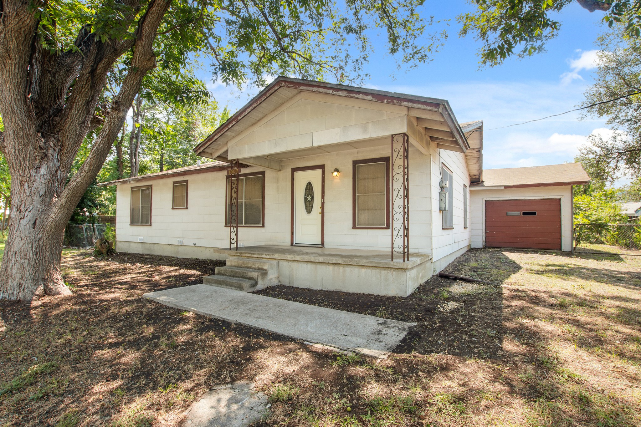 1007 Kimbro Street Taylor, TX 76574 - Photo 3 of 32 a front view of a house with a yard
