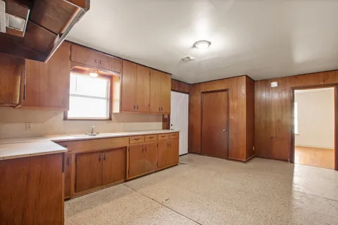 a large bathroom with a large tub sink and mirror