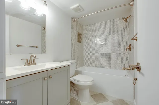 a bathroom with a sink toilet vanity and shower