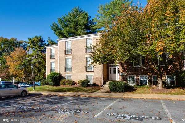 a view of a white house with a street