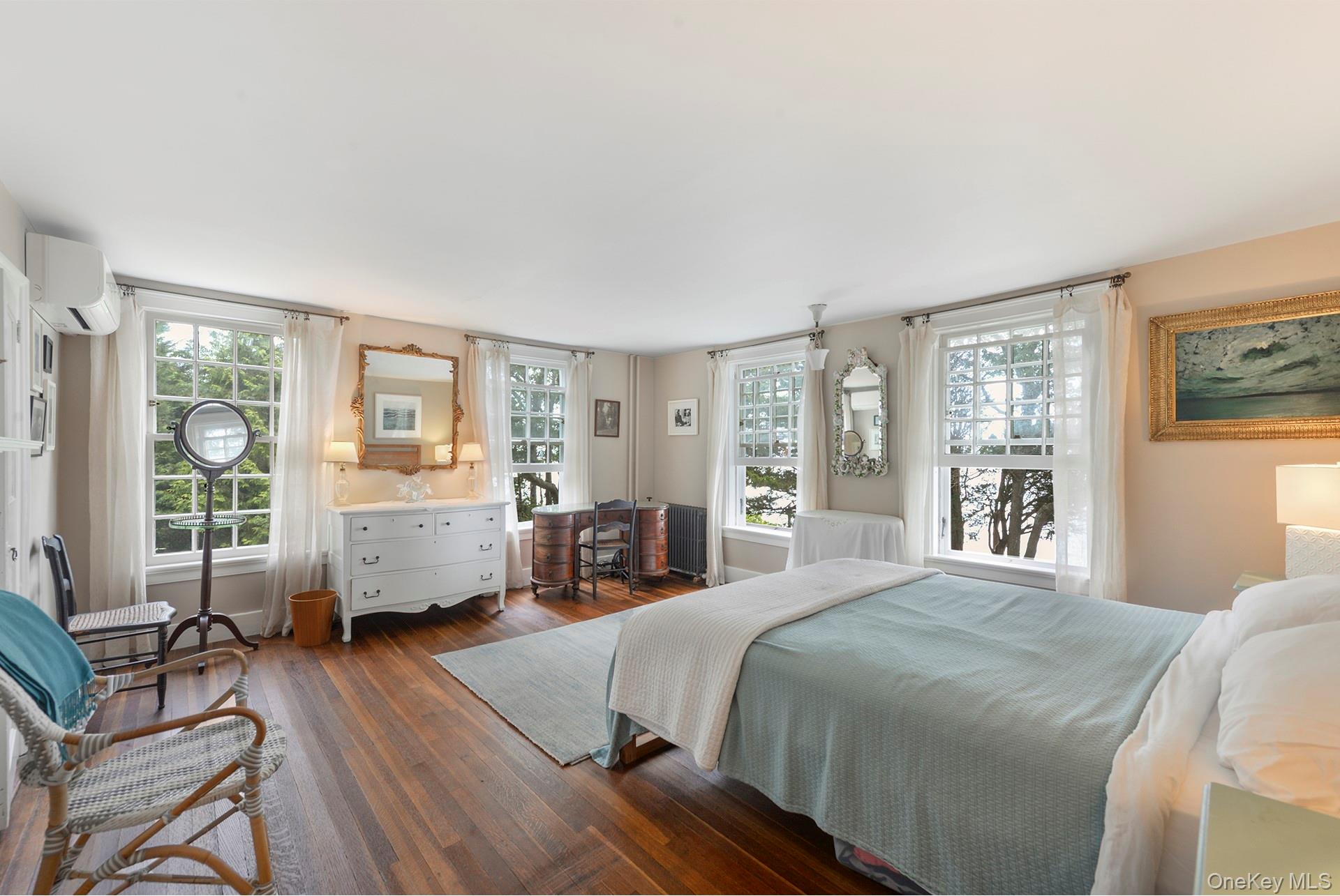 Undisclosed Address Peconic, NY 11958 - Photo 12 of 24 a spacious bedroom with a bed a table and large windows