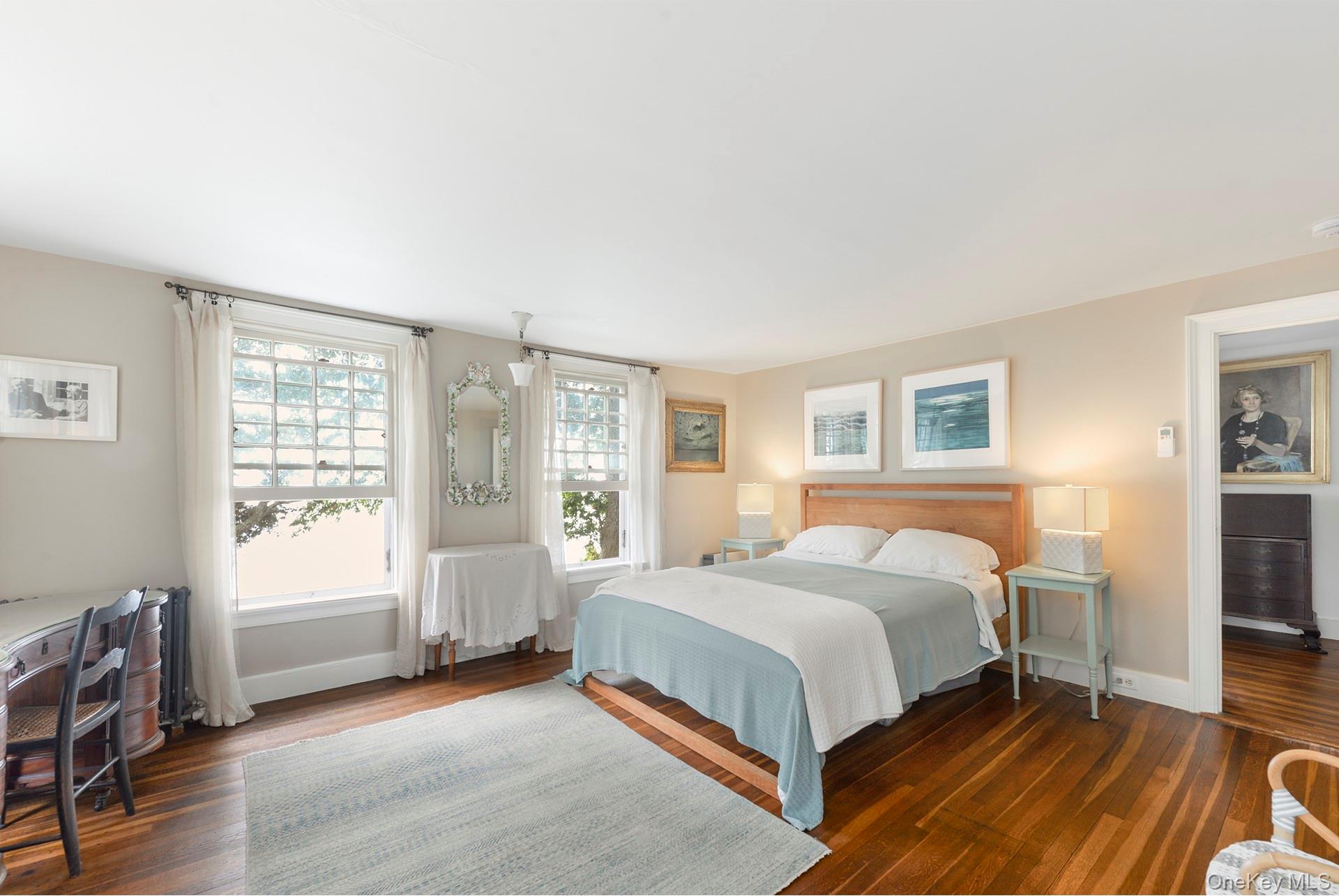 Undisclosed Address Peconic, NY 11958 - Photo 13 of 24 a bedroom with a bed and wooden floor