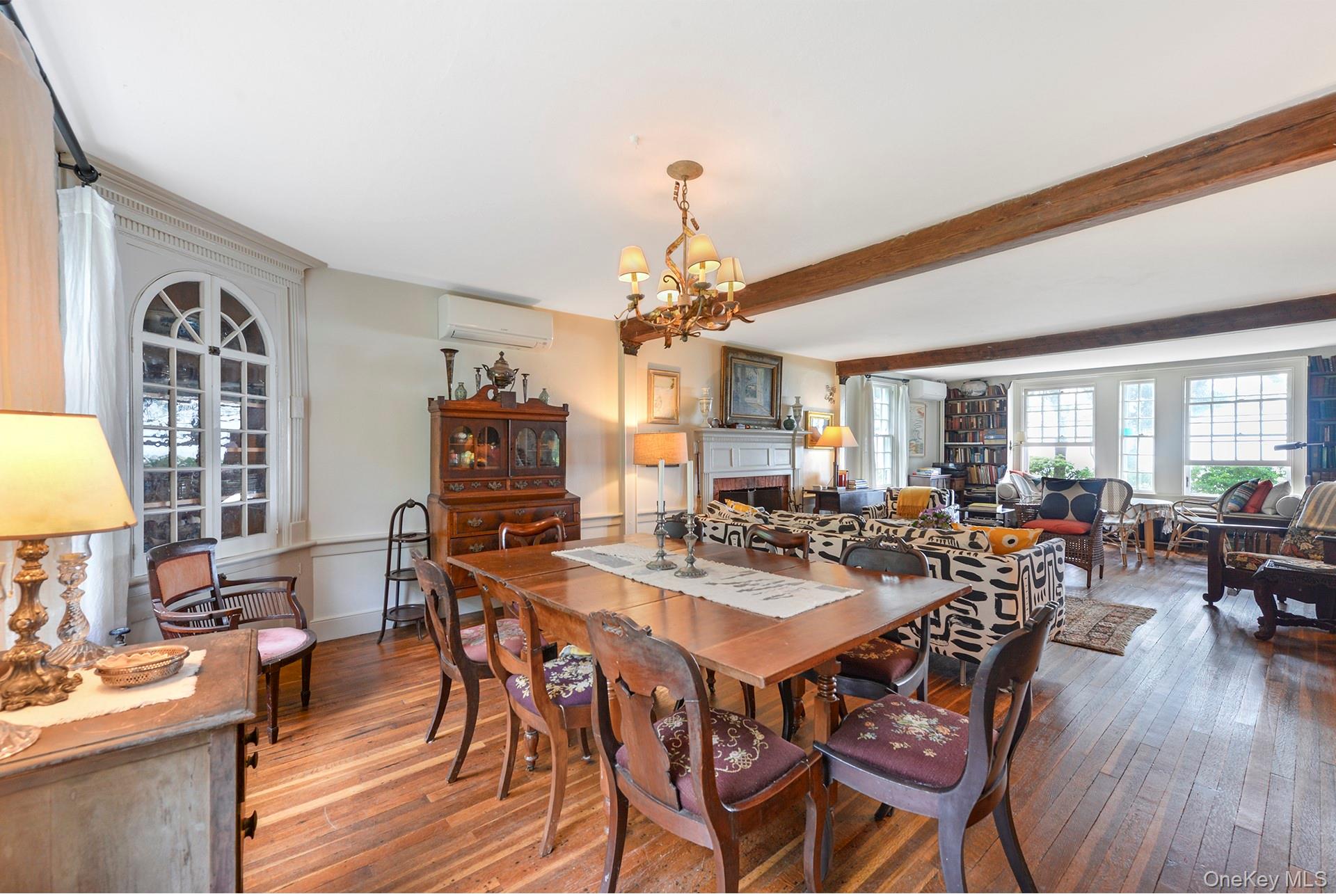 Undisclosed Address Peconic, NY 11958 - Photo 3 of 24 a view of a dining room and livingroom with furniture wooden floor a chandelier