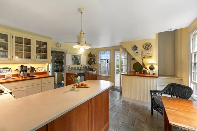 a kitchen with stainless steel appliances granite countertop a sink a stove and a wooden floors