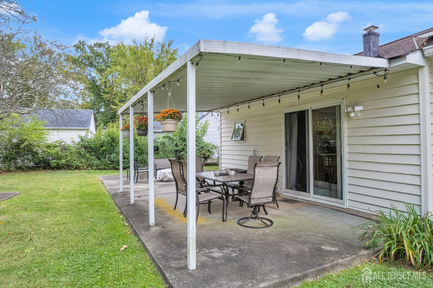 64 Ashley Road Edison, NJ 08817 - Photo 36 of 39 a view of a patio with a table and chairs