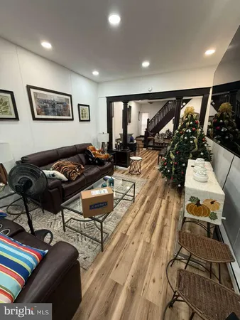 a living room with lots of furniture and a wooden floor