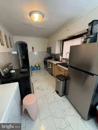 a kitchen with a sink appliances and cabinets
