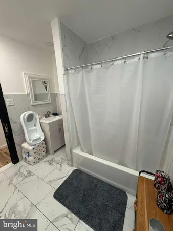 a bathroom with a shower curtain and a sink