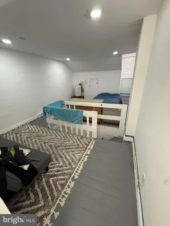 a bed sitting in a room next to a lamp