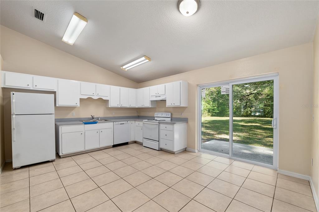 4329 Northwest 155th Street Reddick, FL 32686 - Photo 20 of 52 a kitchen with a sink window and cabinets