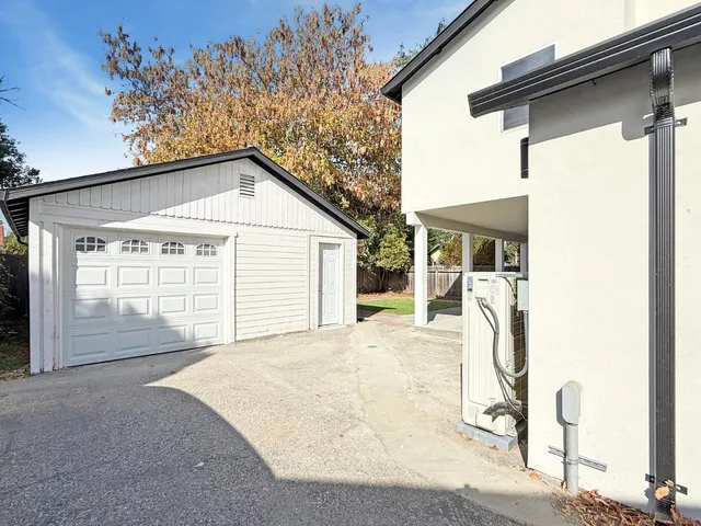 a view of a house with a backyard and garage