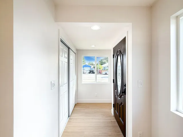a view of hallway with wooden floor