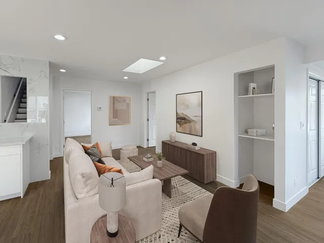 a living room with furniture and wooden floor